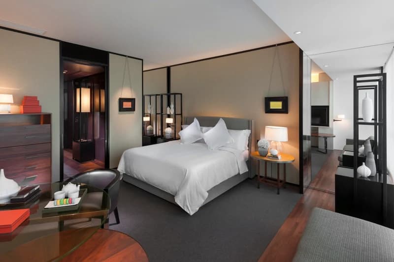 A warm-toned Mandarin Oriental Guangzhou guest room with floor-to-ceiling windows
